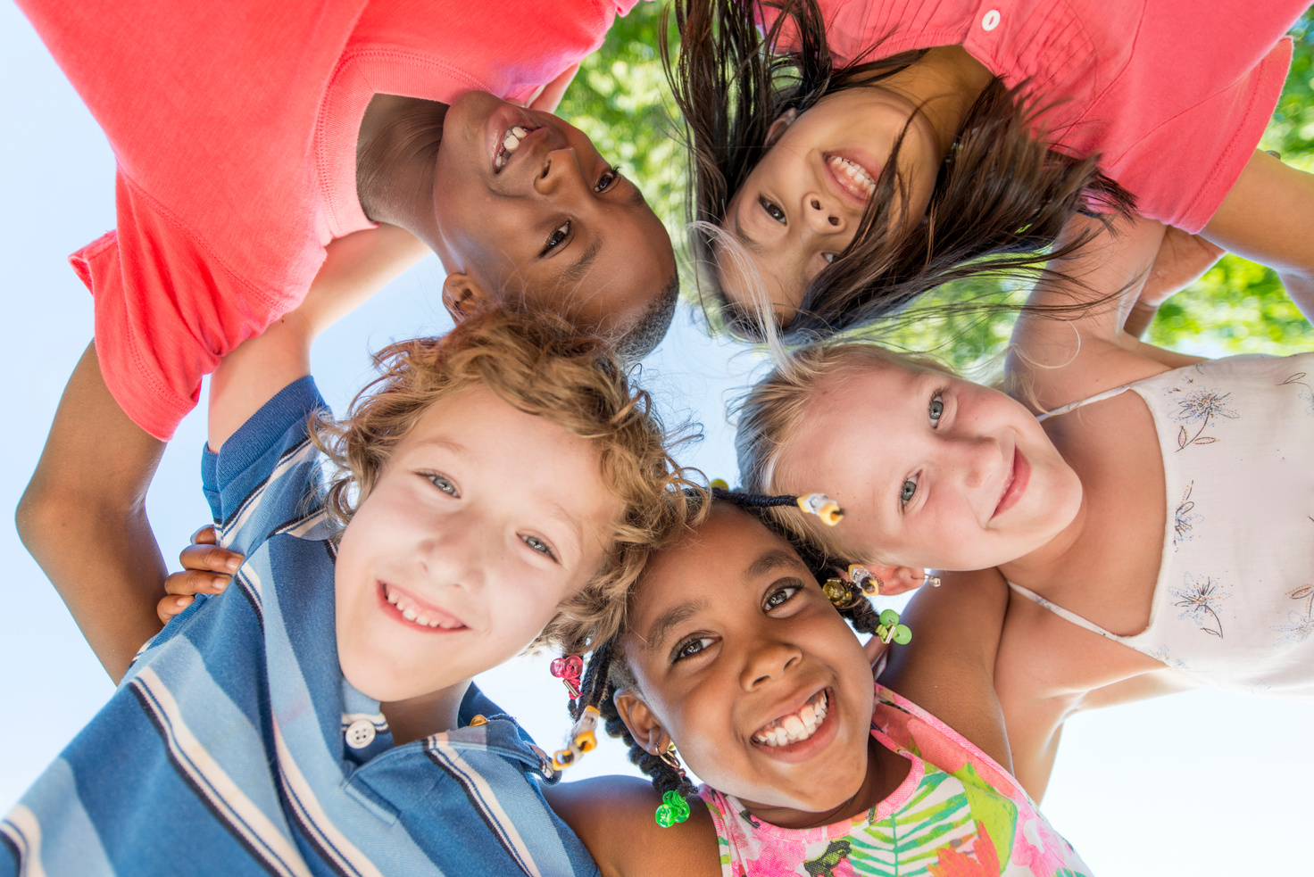 A circle of smiling children looking up